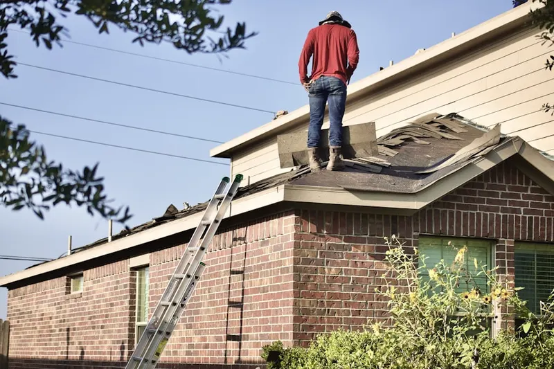 Professional roofer working on a residential roof in North Foxboro
